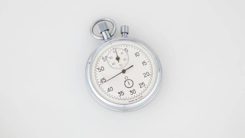 Stopwatch on white table used to illustrate the importance of page speed and SEO